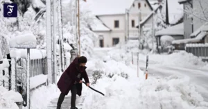 eine-frau-raeumt-schnee-im.webp.webp