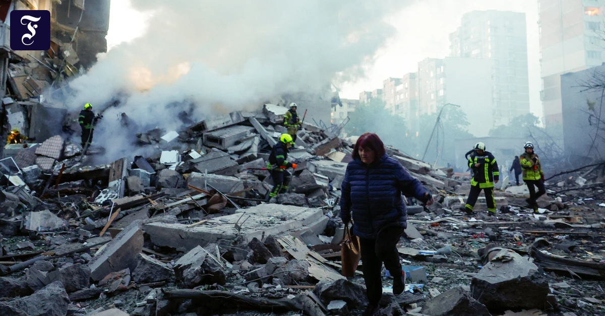 a-woman-walks-amid-rubble-as.webp.webp